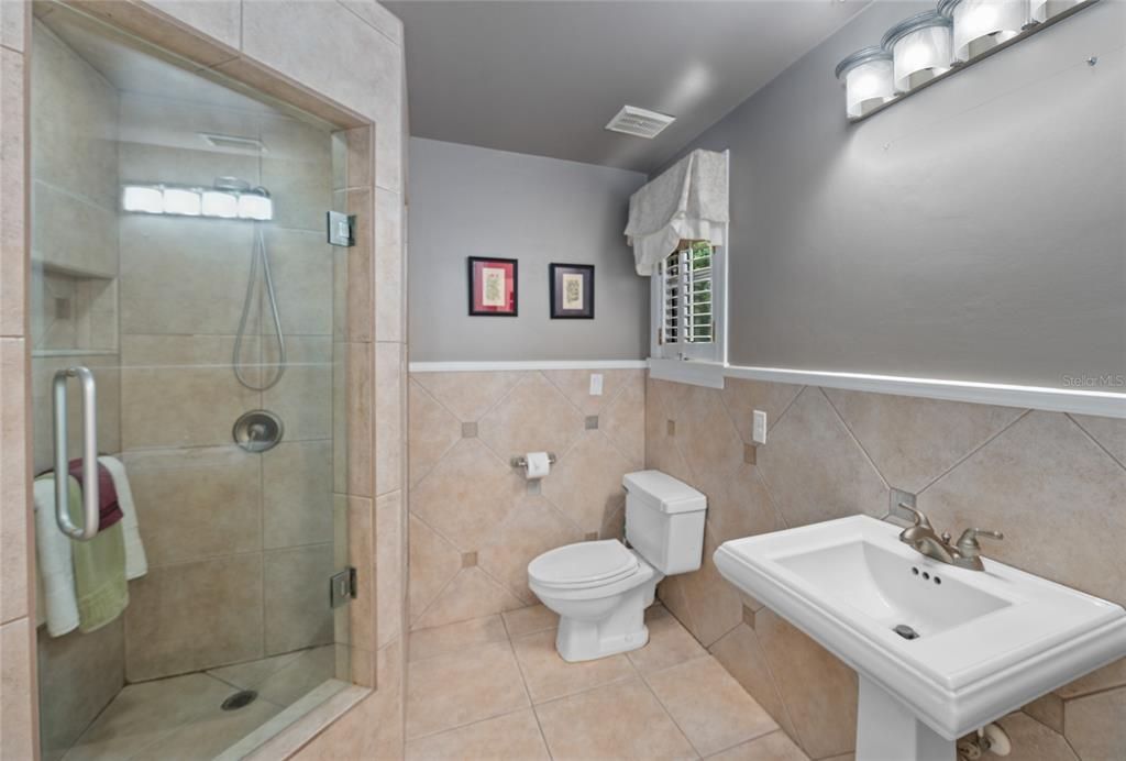 The second Bath is spacious and has a linen closet and step in full tiled shower with a seat and hand bars.