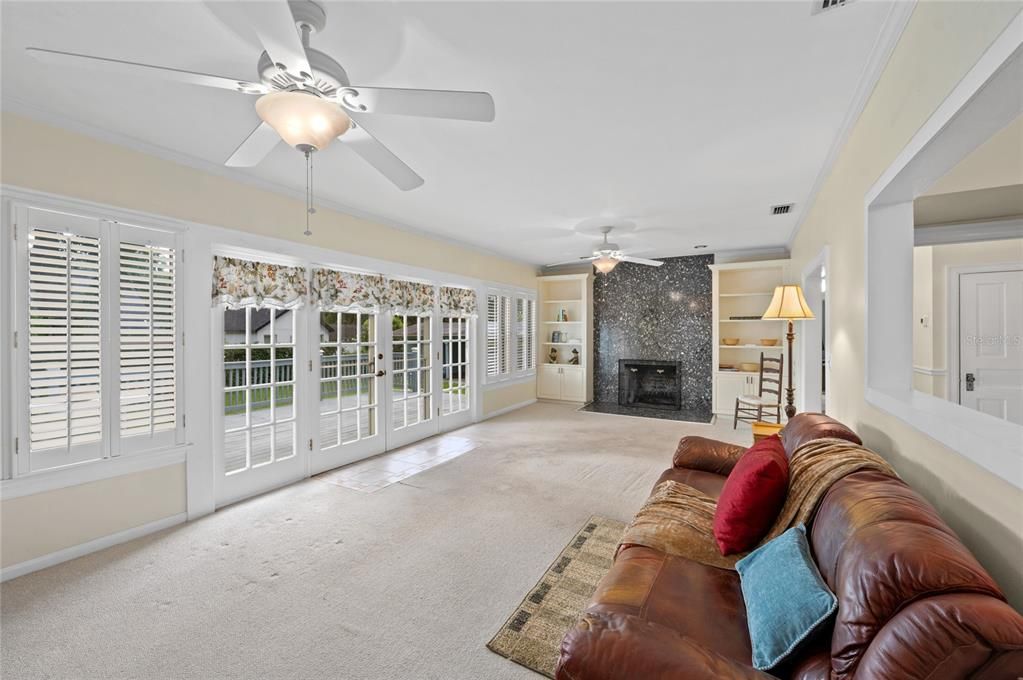 The double french doors in the living room, open to the large wood deck. Let's step outside...