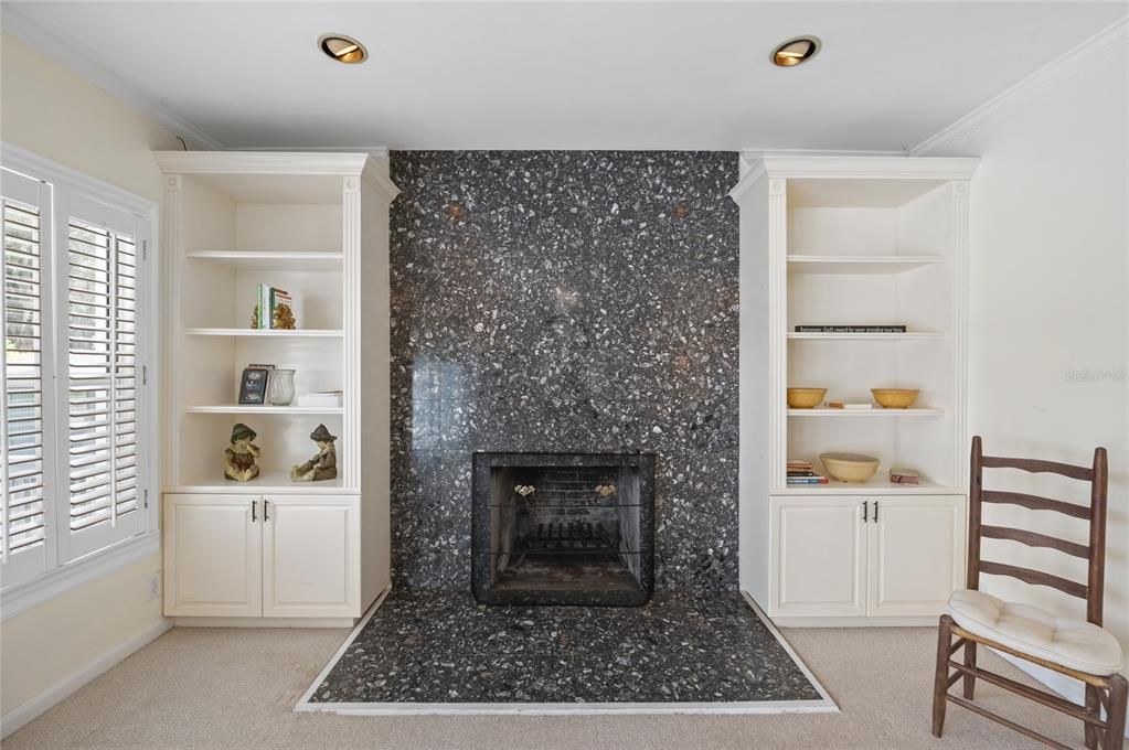 A wood burning fireplace and built in bookcases.