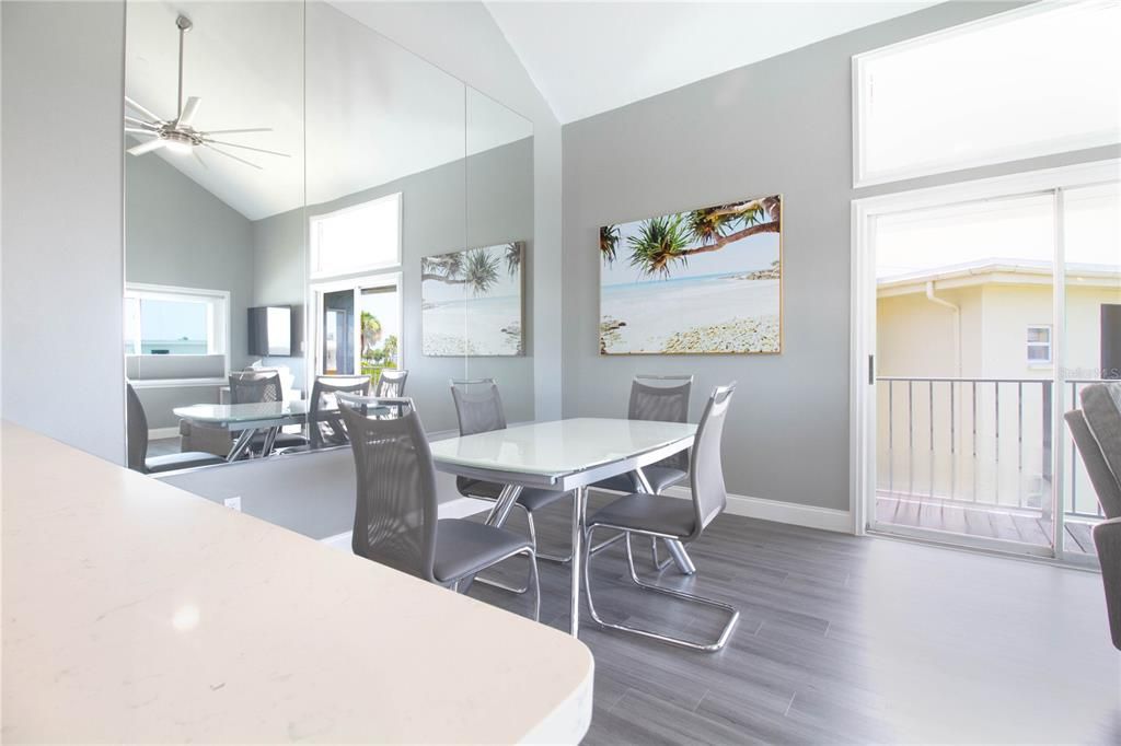 Dining room with huge floor to ceiling mirror to reflect water views, and sliders to open wrap around deck