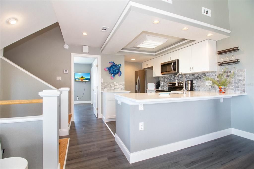 1st floor entry foyer steps open into kitchen - dining - living room open floor plan