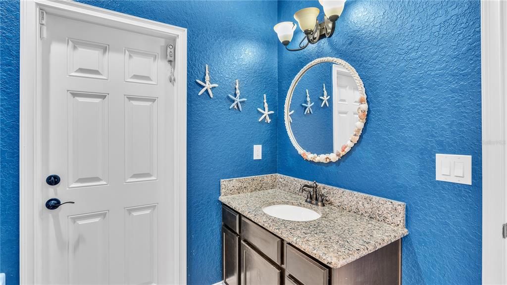 This full bathroom, has a shower and heads directly to the outside kitchen and pool area.