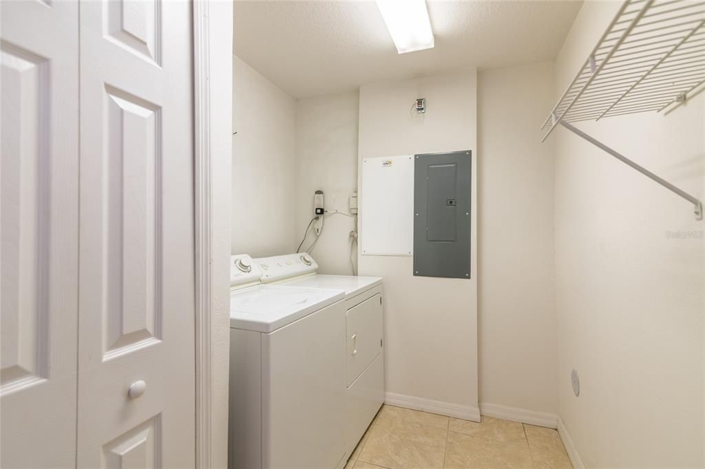Great inside laundry room with storage closet.