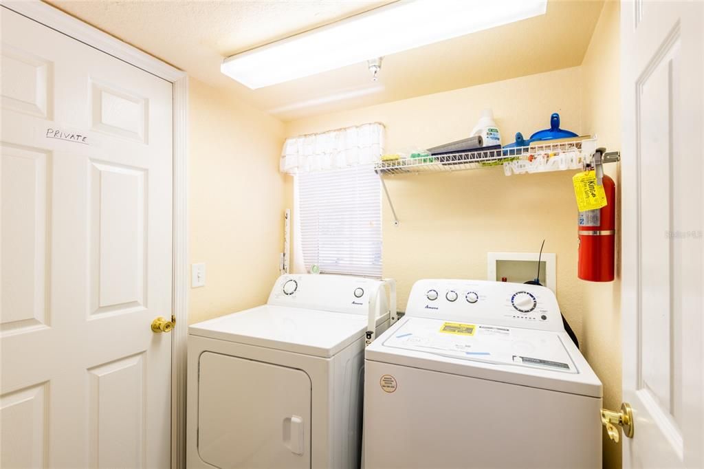 Storage closet to the left of the washer and dryer.