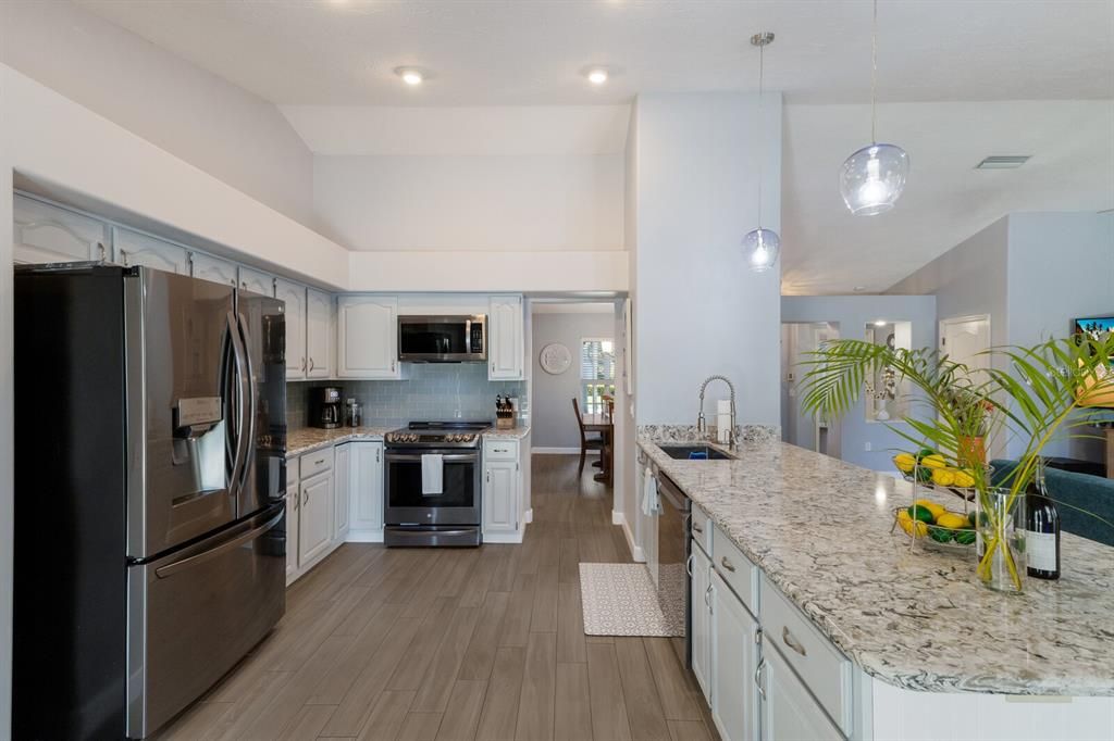 The family chef will enjoy the large open kitchen with a huge quartz countertop that comfortably accommodates up to 5 or 6 barstools, great for engaging with your guests while preparing a meal!