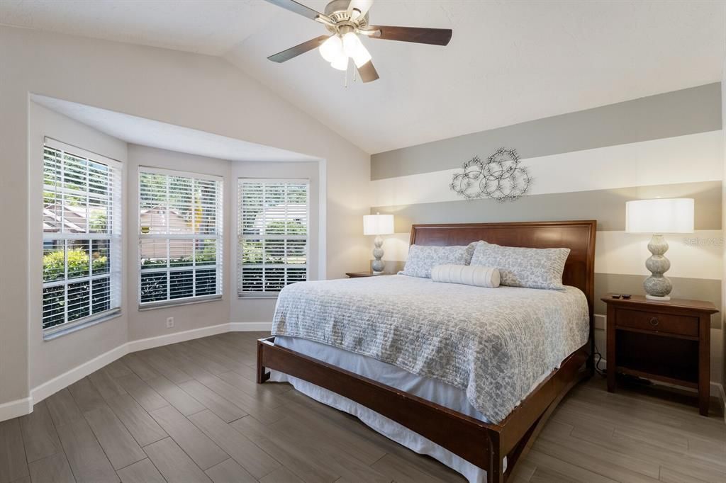 Primary bedroom easily accommodates a king size bed, large end tables and room for a desk in front of the bay windows if needed.  Also enjoys an ensuite bathroom with dual sinks, walk-in closet with custom shelving and separate tub and shower.