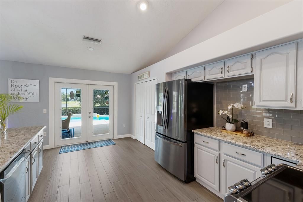 Spacious kitchen with pool views through the new hurricane impact french doors.  All kitchen appliances under 5 years old