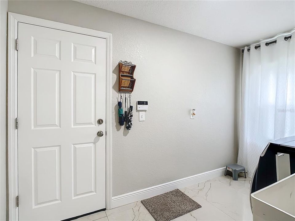 Interior door to garage through laundry room