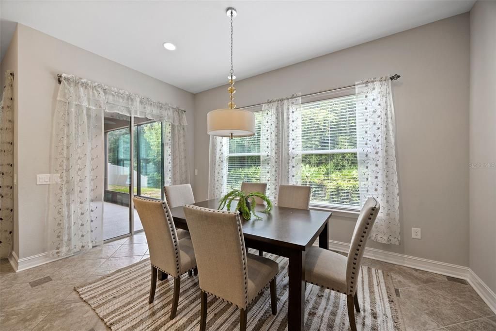 Primary bedroom with seating and view of the backyard