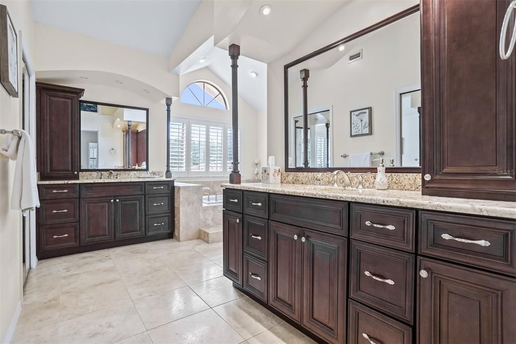 Primary Bathroom with separate vanities custom built in cabinets