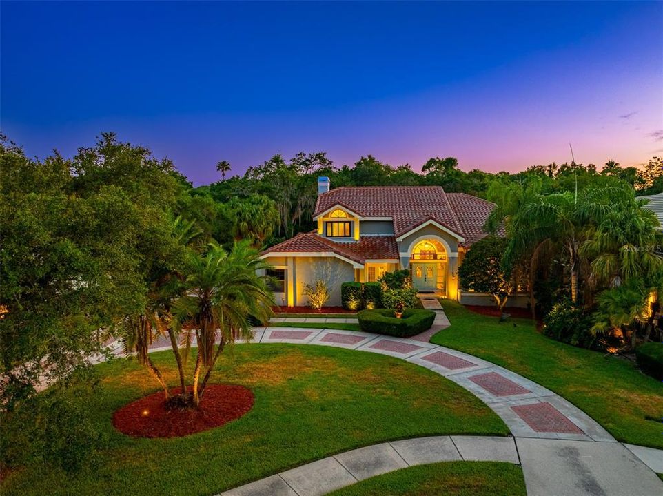 Grand entrance through manicured front lawn