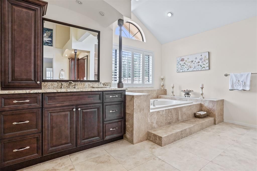 Primary Bathroom with separate vanities custom built in cabinets