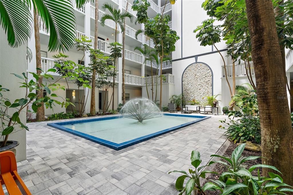 Enjoy the water feature in the serene courtyard