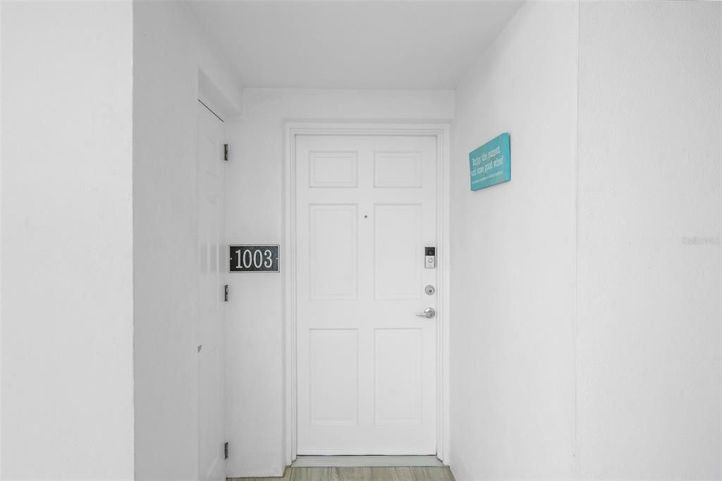 Entry to unit 1003 with convenient utility closet