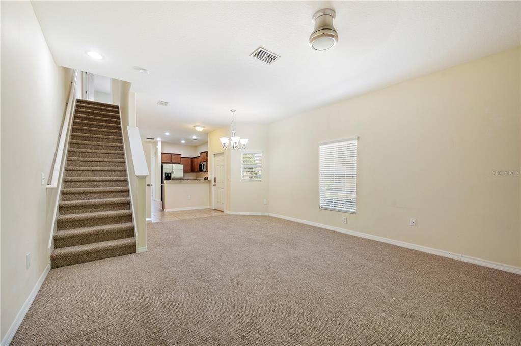 Great Room looking over to front entry and Kitchen