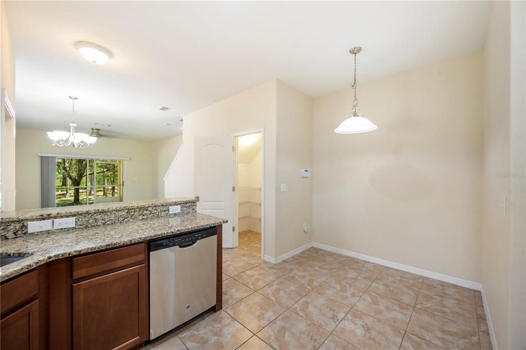 Kitchen with granite counters, stainless steel appliances and tile flooring for easy cleaning