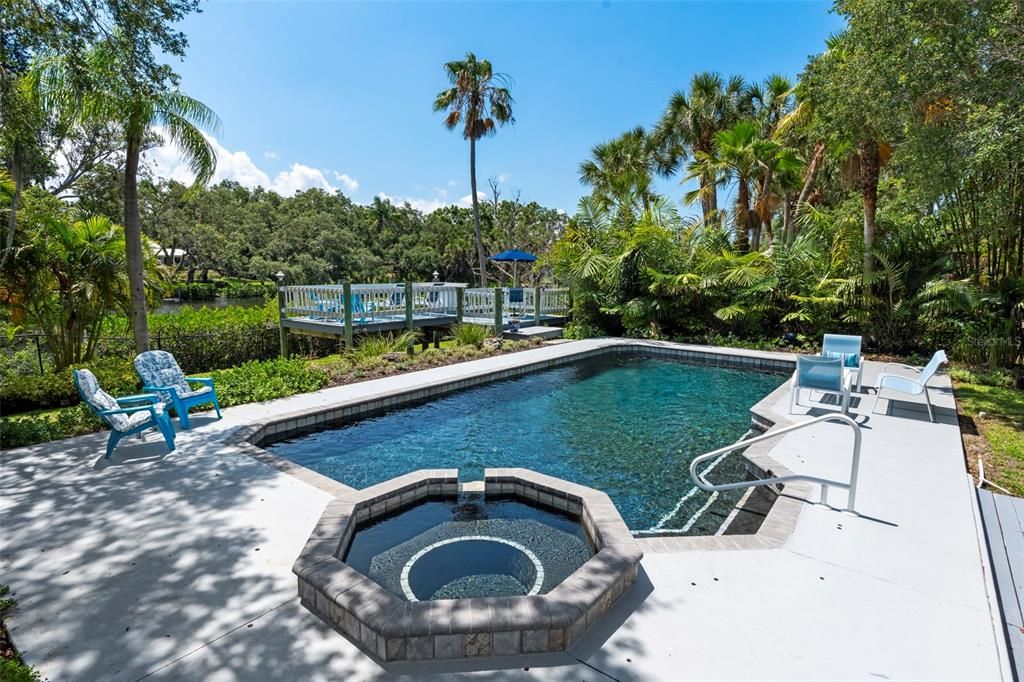 Step outside, feeling the balmy breezes and discover a large heated pool, a private dock with a 8,000 lb boat lift, lounge and outdoor dining areas, kayak storage, a playscape, and stone walking paths.