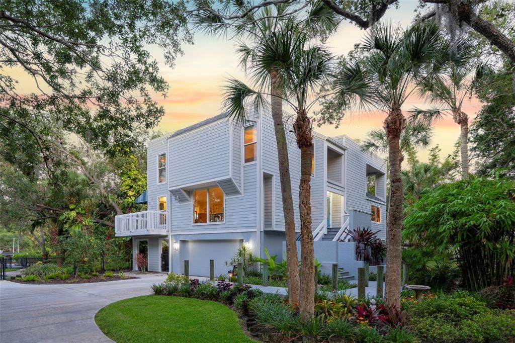 Welcome to 2385 Fiesta Drive, a serene and private oasis nestled on the peaceful boating waters of Phillippi Creek in Sarasota, FL. This exquisite property spans almost an acre, adorned with mature canopied Oak trees draped in Spanish moss, offering tranquility and natural beauty.