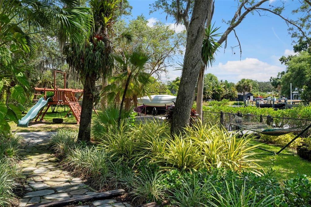 Step outside, feeling the balmy breezes and discover a large heated pool, a private dock with a 8,000 lb boat lift, lounge and outdoor dining areas, kayak storage, a playscape, and stone walking paths.