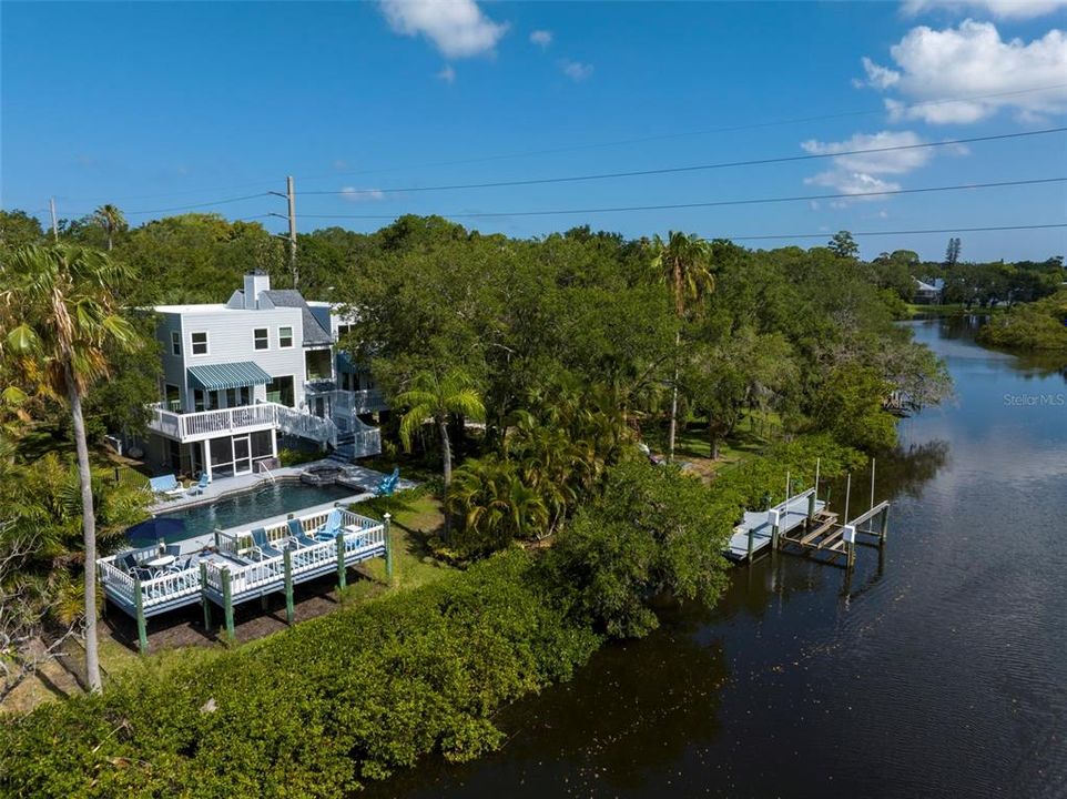 Step outside, feeling the balmy breezes and discover a large heated pool, a private dock with a 8,000 lb boat lift, lounge and outdoor dining areas, kayak storage, a playscape, and stone walking paths.