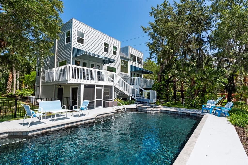 Step outside, feeling the balmy breezes and discover a large heated pool, a private dock with a 8,000 lb boat lift, lounge and outdoor dining areas, kayak storage, a playscape, and stone walking paths.