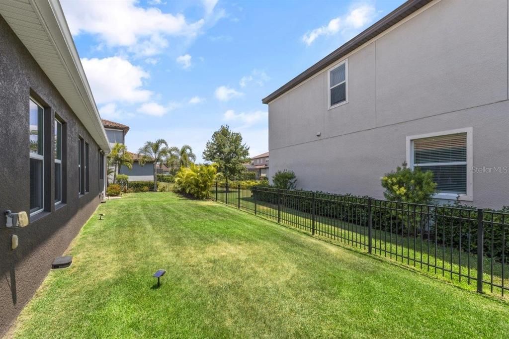 Fenced-in side yard with mature landscaping.