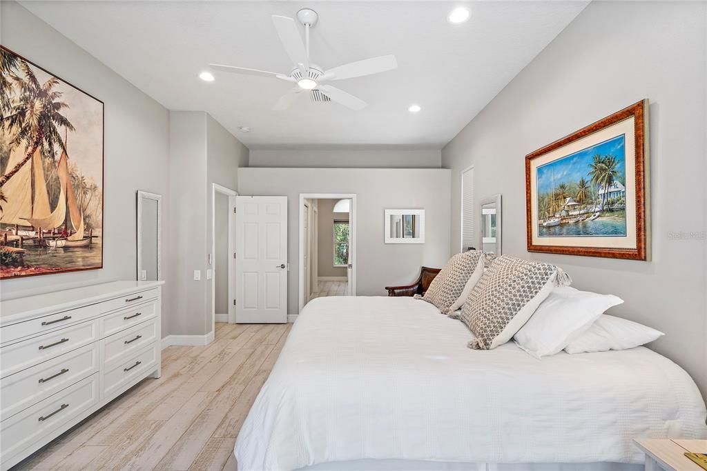 Hallway to primary bath -walk-in closets on each side