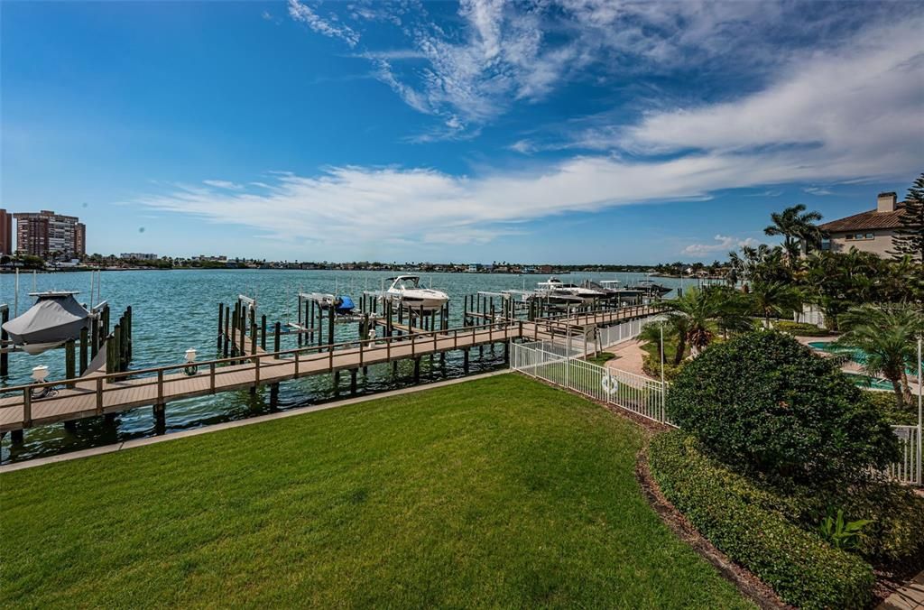 .. View From the Balcony of  La Bahia Residence #202... Many a day in the Springtime and Summer You will spot Manatees and Dolphins Frolicking off the Docks. The Manatees are looking for the fresh sweet grass they like that only sprouts during Spring & Summer and the Dolphins are training their Calves in the Protected Waters of Boca Ciega Bay.