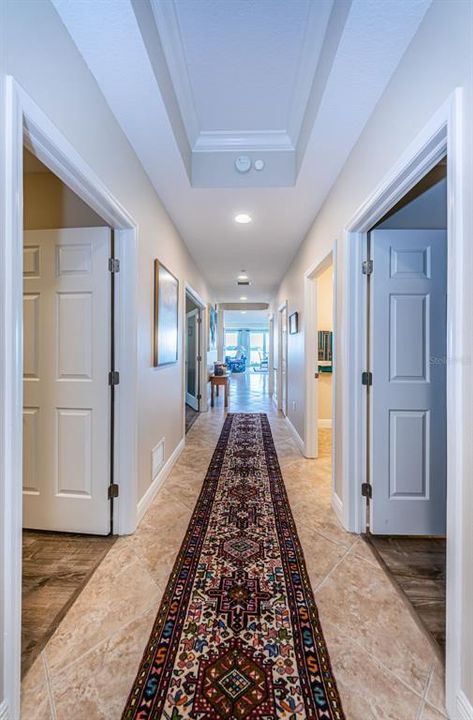 .. Hallway Shot from Unit Entrance Door.. Main On- Suite Guest Bedroom Thru Door on Left... Second Smaller On-Suite Guest Bedroom on Right Side Thru Door.  Beautiful Tile Thru Foyer and Wet Areas.