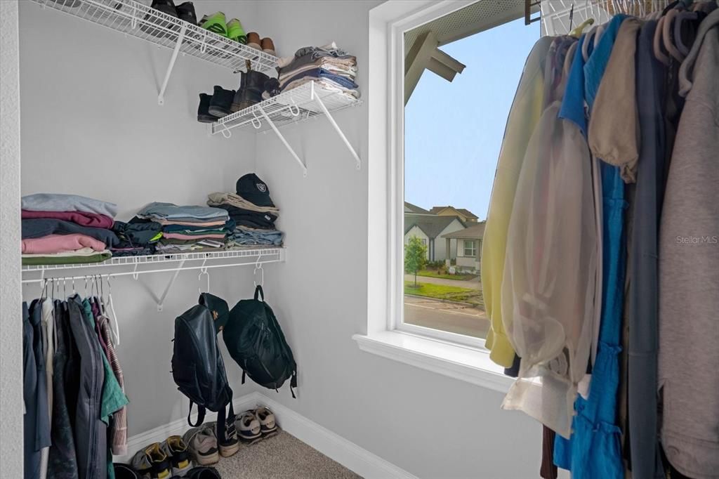 Primary bedroom walk in closet 1