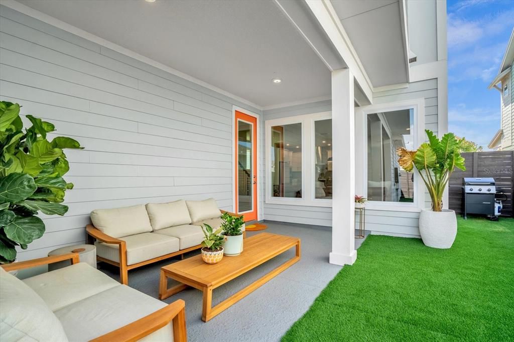 Back Patio w Fenced yard and year round turf.