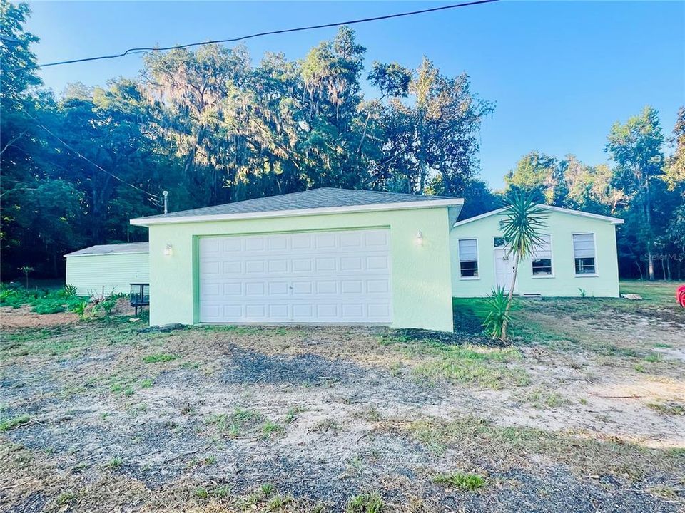 Cement block 2 car garage (connected with a cement slab patio).  The possibilities are endless here!  With privacy, space and NO FLOOD ZONE, This property is a winner!