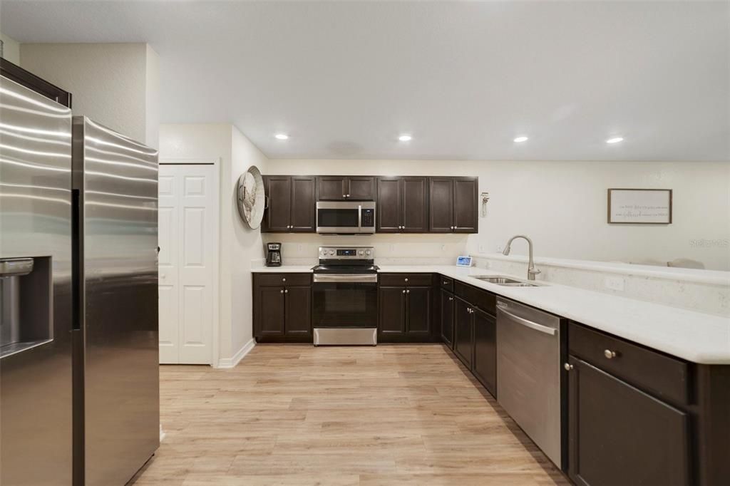 The kitchen was designed with the home chef in mind and features STAINLESS STEEL APPLIANCES, espresso cabinetry, breakfast bar seating and a pantry for ample storage.