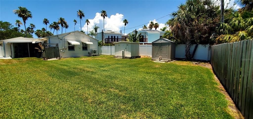 Back yard including 2 storage sheds & private shower