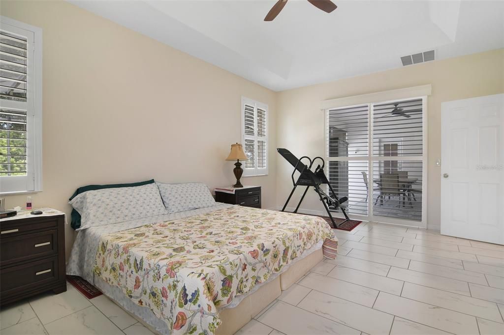 Primary suite with tray ceiling and pool/lanai access