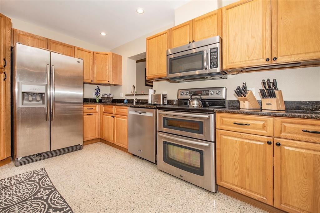 Open kitchen seeing into back florida room and living room