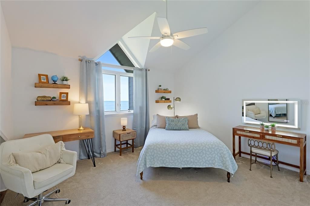 The view from the large 3rd level bedroom is framed by a vaulted window and high ceilings.
