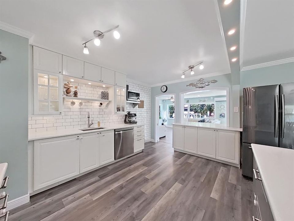 Bright Kitchen with glass lighted cabinetry, easy-wipe surfaces, and water views!