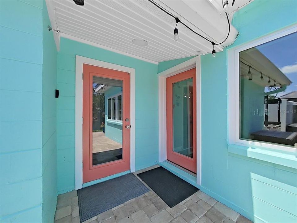 Fresh paint, vibrant colors, & glass doors! So many little details add to the modern tropical vibe of this home!