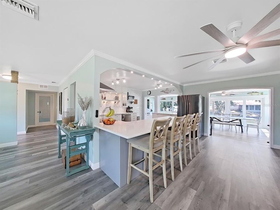 A large Kitchen peninsula with Quartz countertops, room to seat at least 4! Water views extend from Kitchen through your Great Room!