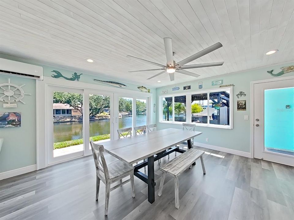 Dining area of the Great Room. 12-foot impact-rated glass sliders provide easy access to your backyard oasis. Your outdoor kitchen is through the single french door on the right!