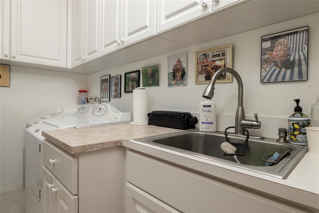 Large inside laundry room with many storage cabinets