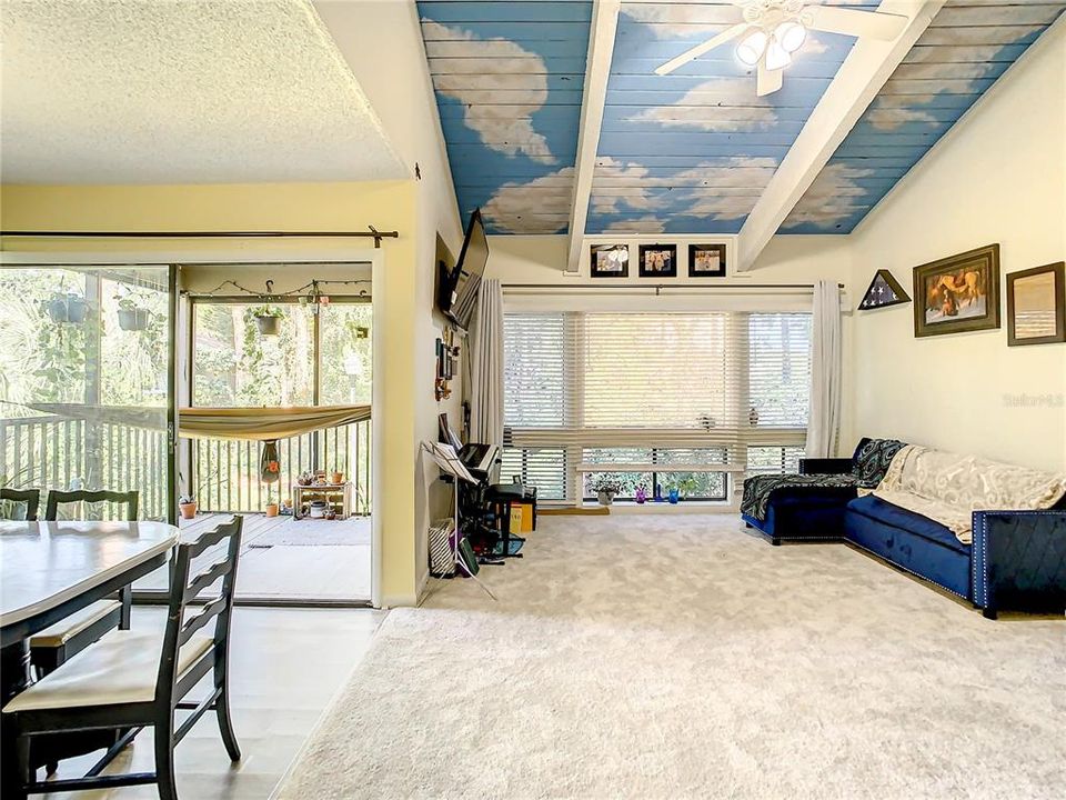 Large living room beside the dining area with stunning wooden beams.