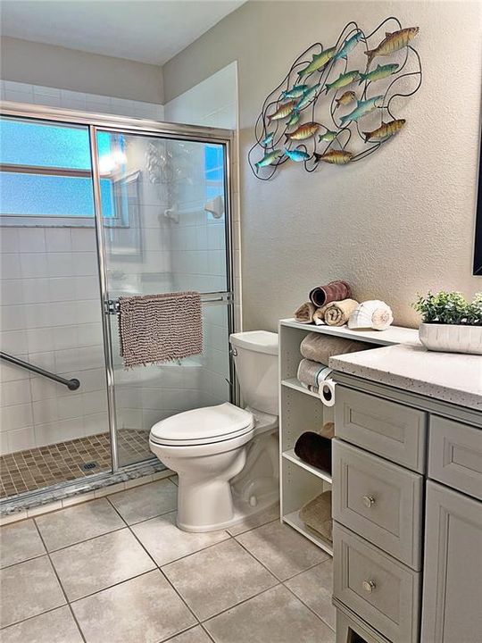 Master bedroom with ceramic tile flooring, new cabinets, and quartz countertop