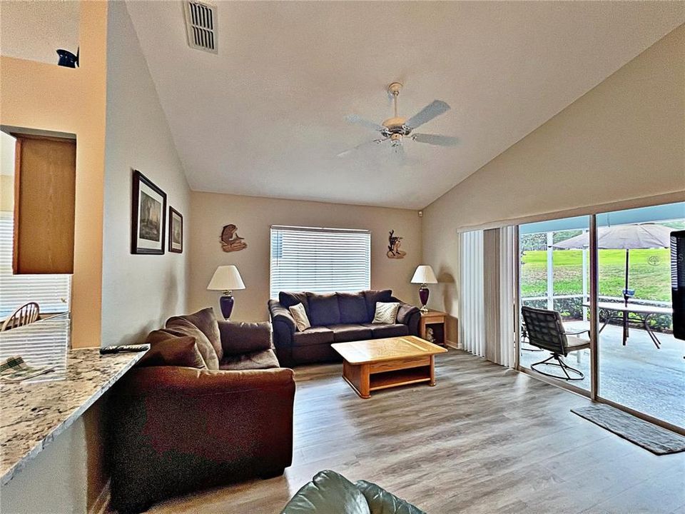 From dining room of view of the front entry, living room, and kitchen