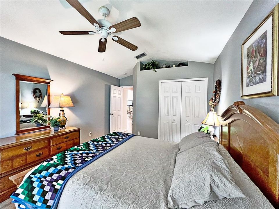 Bedroom number two with view of hallway leading to bathroom and closet