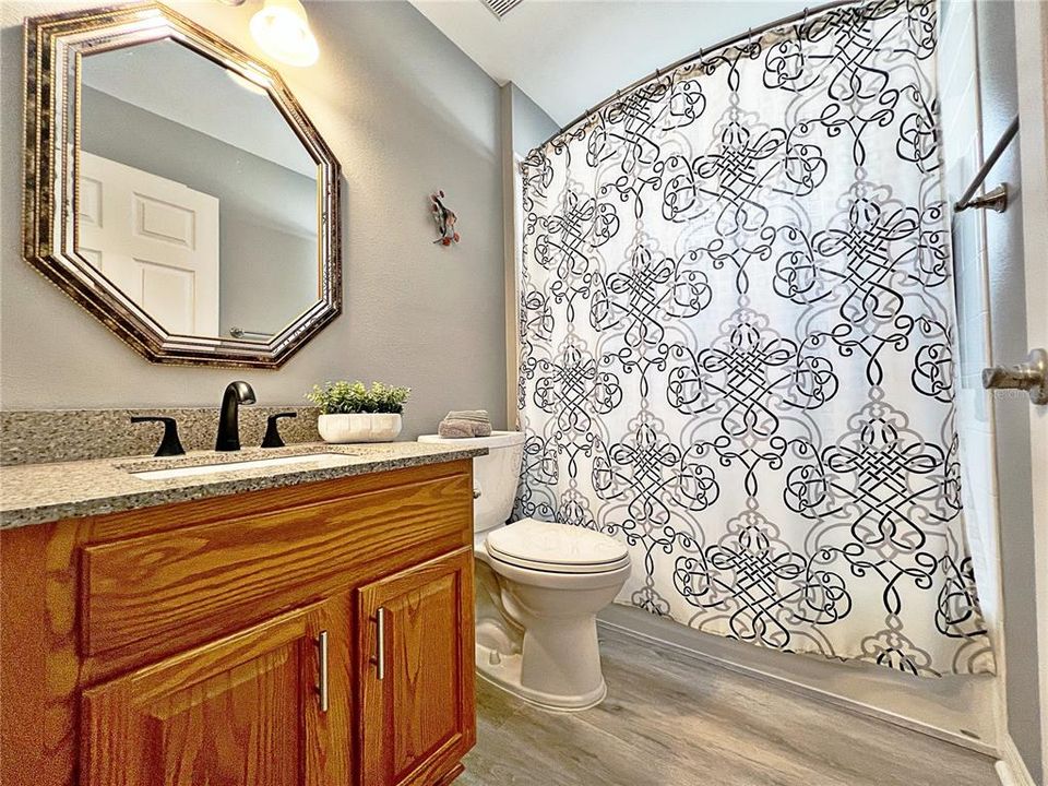 Bathroom two with tub, shower combo, solid wood cabinet with quartz countertop