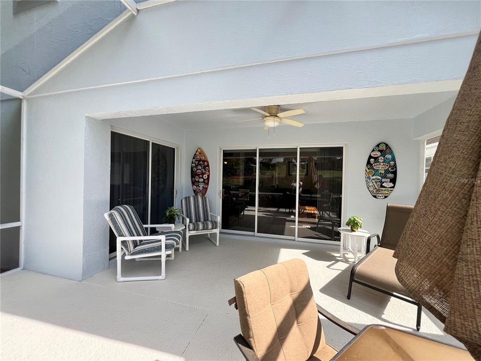 Additional view of covered lanai with sliders into master bedroom and living room room