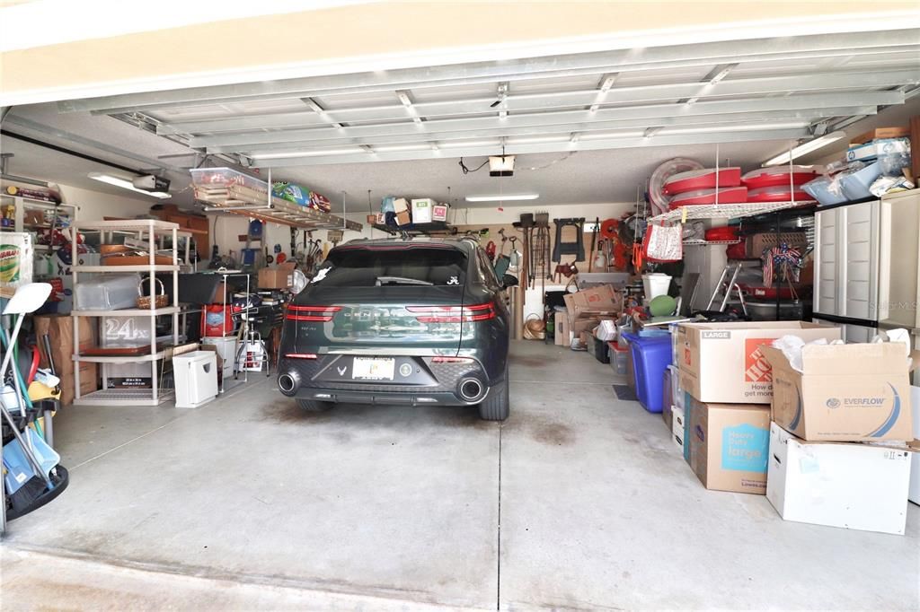 expanded garage accommodates 2 cars plus a golf cart and has lots of storage space