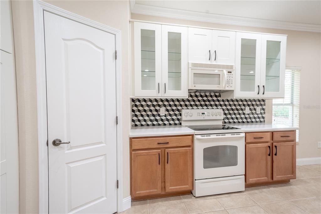 Upper cabinets with glass shelves and doors compliment the wood cabinets below.